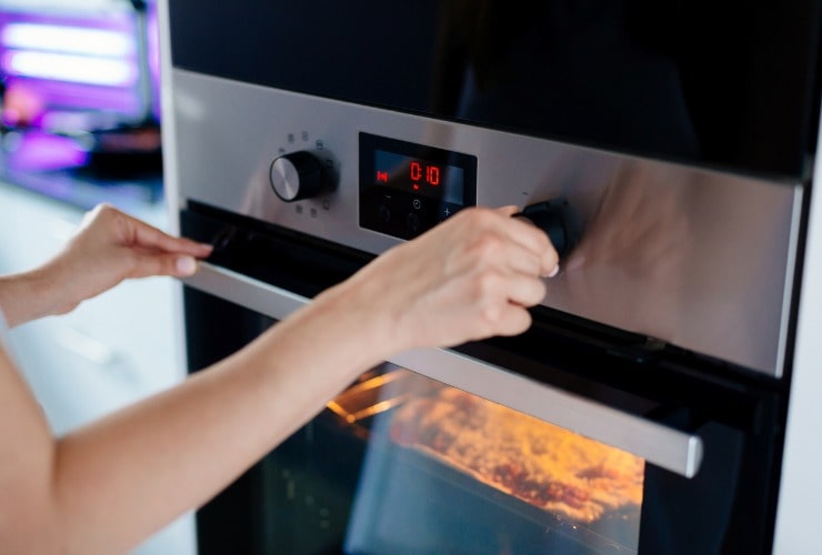 Donna regola tempo di cottura del forno