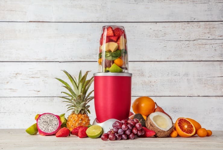 Blender with pieces of fruit