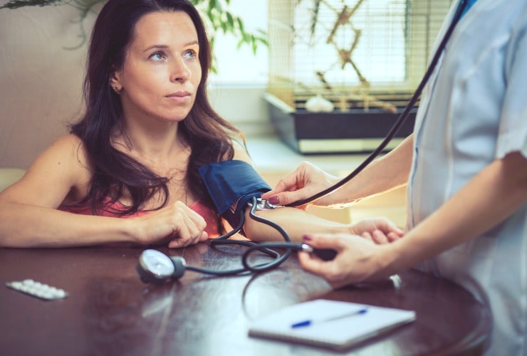 Doctor measures high blood pressure