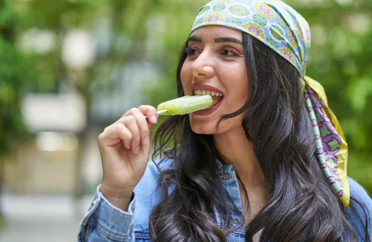 Ice cream, young woman eating lollipop